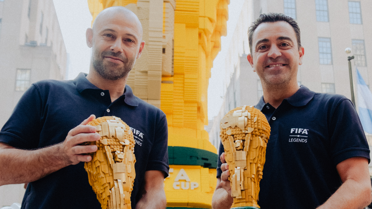Xavi Hernández and Javier Mascherano with LEGO World Cup trophies